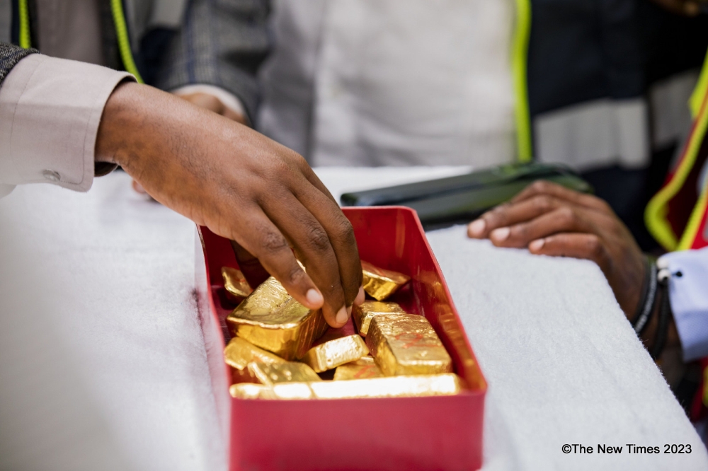 A worker showcases processed gold at Gasabo Gold Refinery (GGR) in Kigali on December 1, 2023. According to RMA, reducing taxes on minerals, including gold, could attract investors to the country, and stimulate interest in selling processed minerals. Photo by Emmanuel Dushimimana