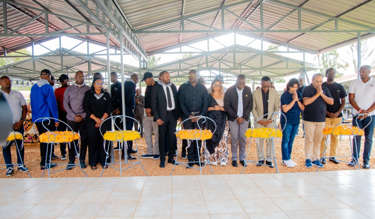 Mourners observe a moment of silence to pay respect to victims of the Genocide against the Tutsi