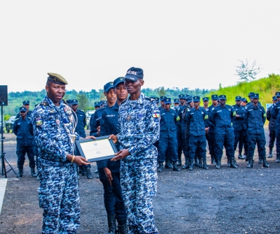 The Director General of CAR National Police, Controller-General Bienvenu Zokoue awarding a certificate of merit to a law enforcement officer from CAR who emerged as one of the course&#039;s best students.