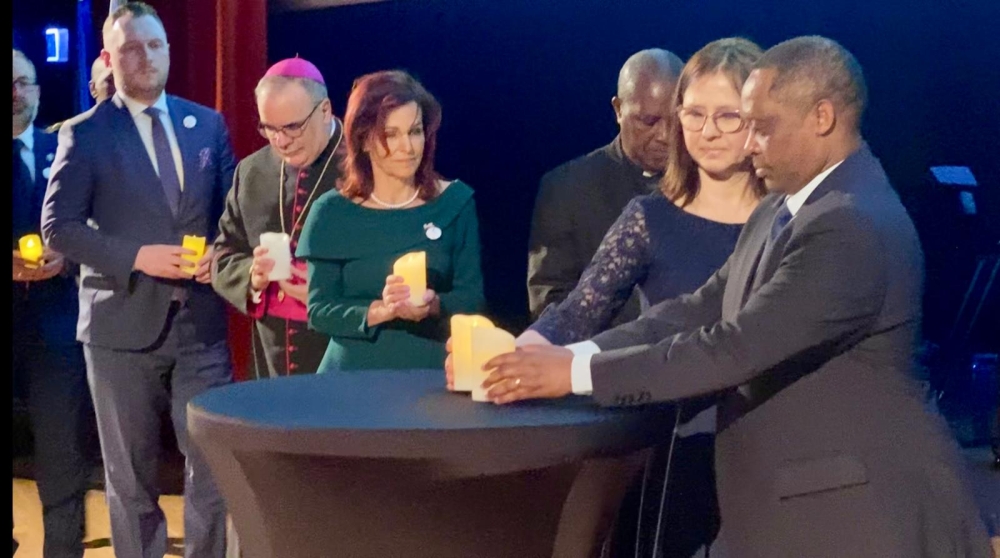 Ambassador of Rwanda in Poland Anastase Shyaka(R) leads other officials to light candles to honour victims during the  commemoration of the 1994 Genocide against the Tutsi in Poland,  on April 26.