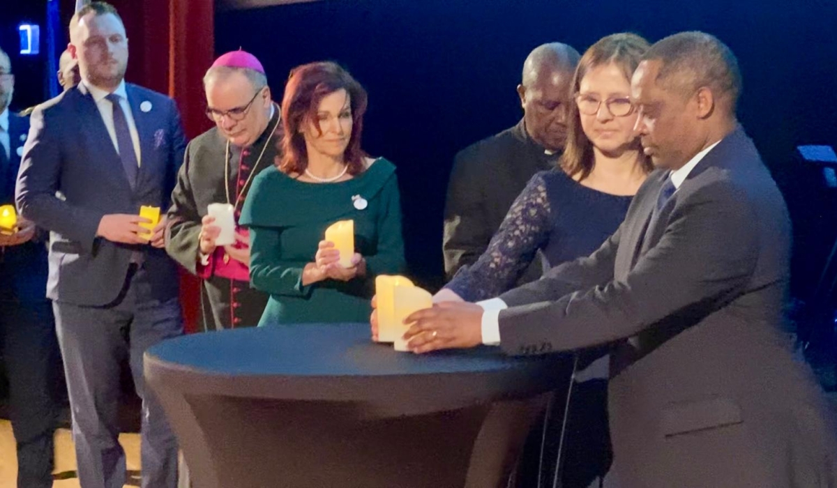 Ambassador of Rwanda in Poland Anastase Shyaka(R) leads other officials to light candles to honour victims during the  commemoration of the 1994 Genocide against the Tutsi in Poland,  on April 26.
