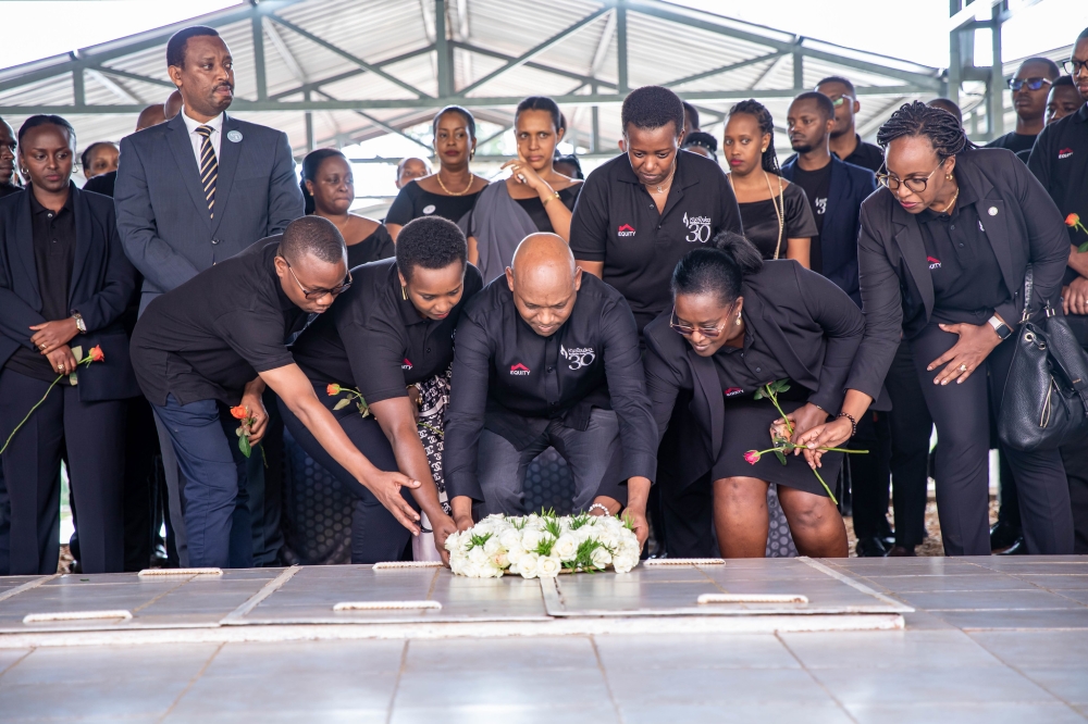 Hannington Namara, Managing Director of Equity Bank Rwanda (c) with other bank officials lay a wreath to pay tribute to victims of the Genocide against the Tutsi on April 30. Dan Gatsinzi