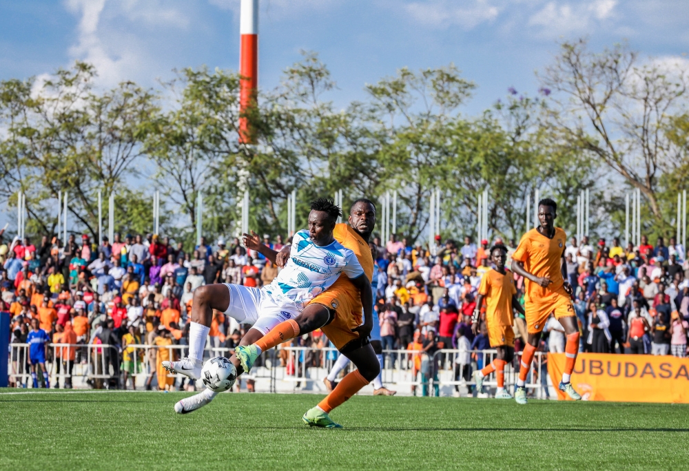 Players vie for the ball during the match Players vie for the ball during the match