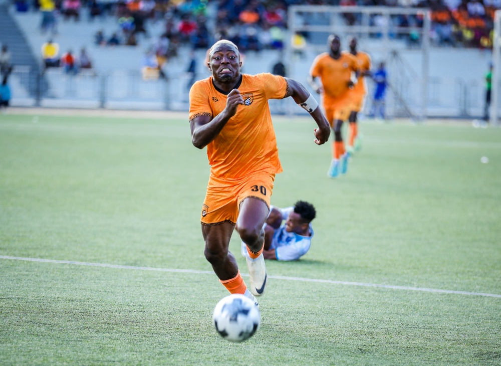 Striker Elijah controls the ball during the match