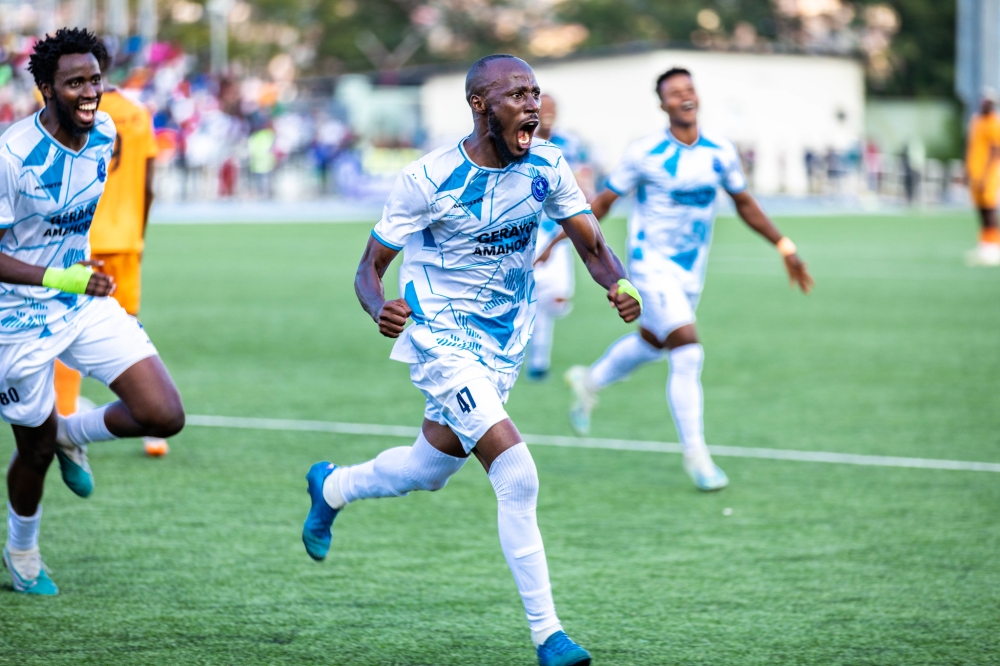 Goal scorer Eric Nsabimana leads his teammates to celebrate the goal