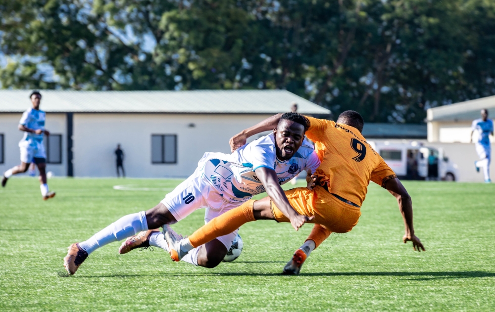 Midfielder Muhadjili Hakizimana vies for the ball with Bugesera Fc's player at Kigali Pele stadium Midfielder Muhadjili Hakizimana vies for the ball with Bugesera Fc's player at Kigali Pele stadium