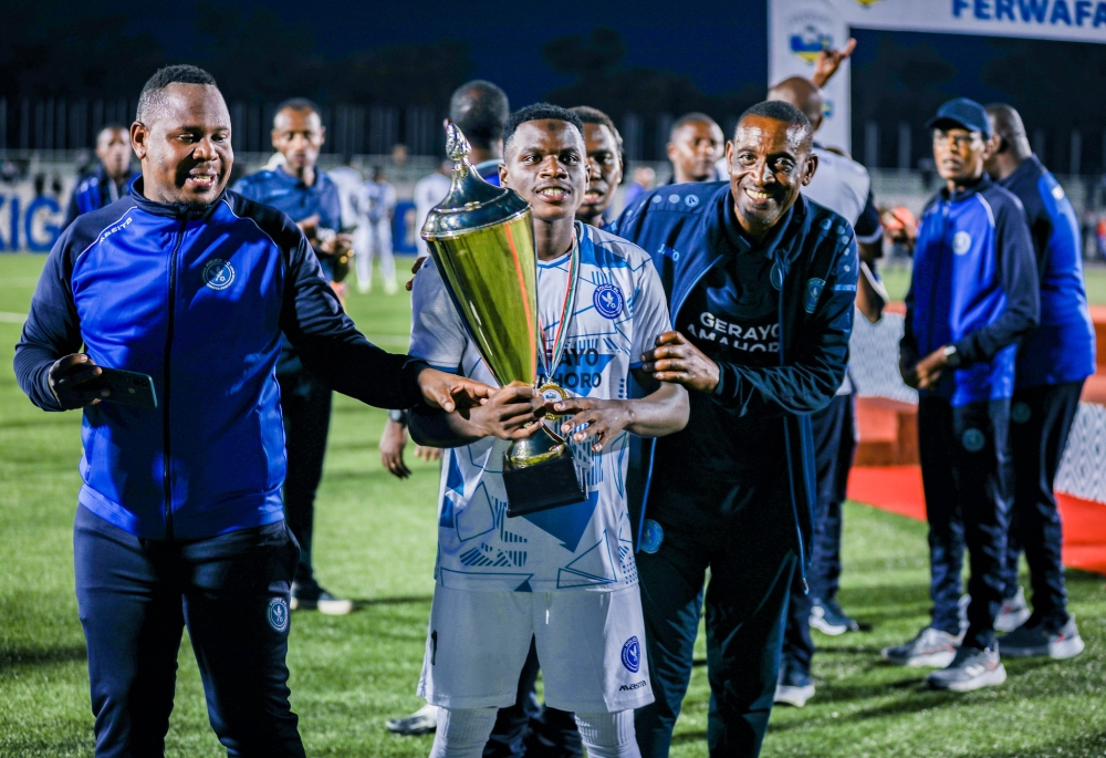 Police FC players and staff celebrate the 2024 Peace Cup trophy, their first since 2015.  The law enforcers won the title after beating Bugesera FC 2-1 in the final held at Kigali Pele Stadium on Wednesday, May 1. All photo by Craish Bahizi