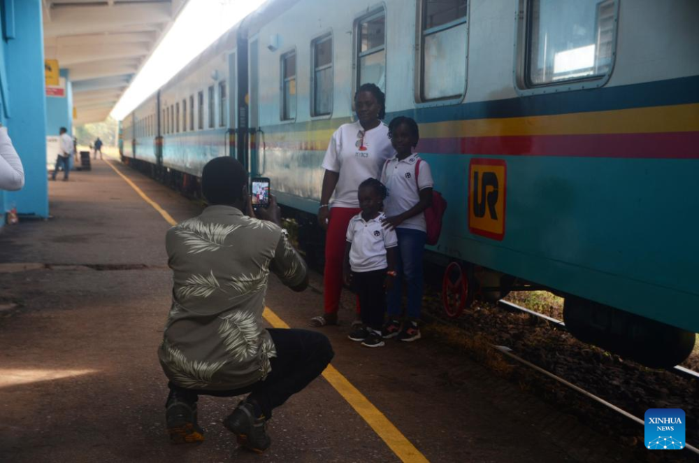 Passengers pose for photos at a train station in Kampala, Uganda, May 2, 2024. (Photo by Nicholas Kajoba/Xinhua)
