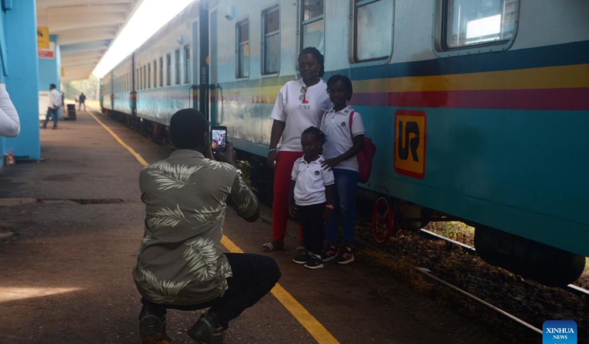 Passengers pose for photos at a train station in Kampala, Uganda, May 2, 2024. (Photo by Nicholas Kajoba/Xinhua)