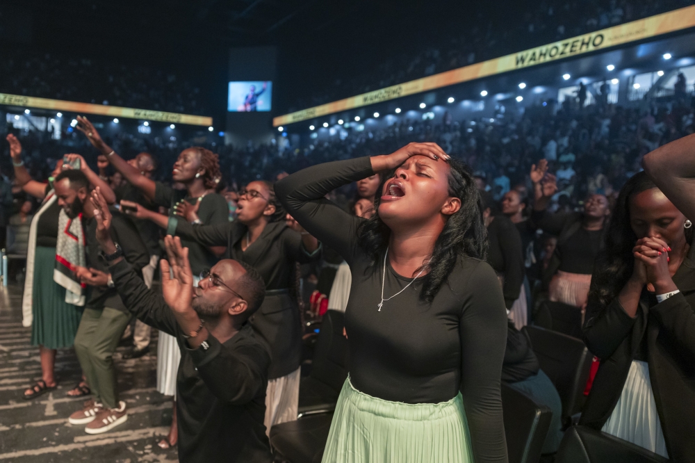 Revelers during a praise and worship session at Wahozeho album launch at BK Arena on Sunday, May 5. Ndasingwa, who was launching his debut album ‘Wahozeho’, became the second gospel musician to fill out BK Arena. All photos by Olivier Mugwiza