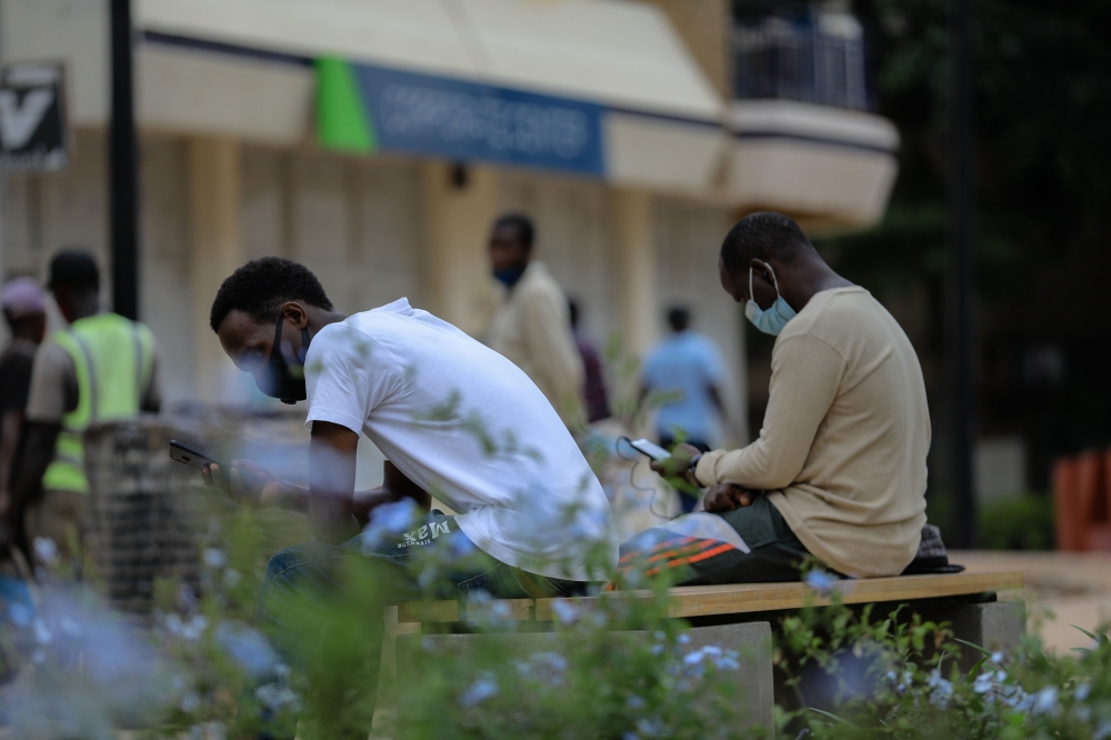 Some youths using a free wireless at Imbuga City walk in Nyarugenge District. Photo by Craish Bahizi 