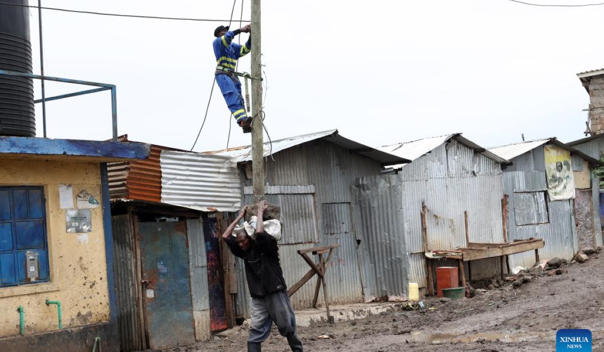 An engineer works on a power line pole in Nairobi, Kenya, May 6, 2024. UN humanitarians said on Monday nearly 750,000 people were affected by flooding in eastern Africa, with 234,000 displaced and more than 236 killed - more than 229 in Kenya alone.