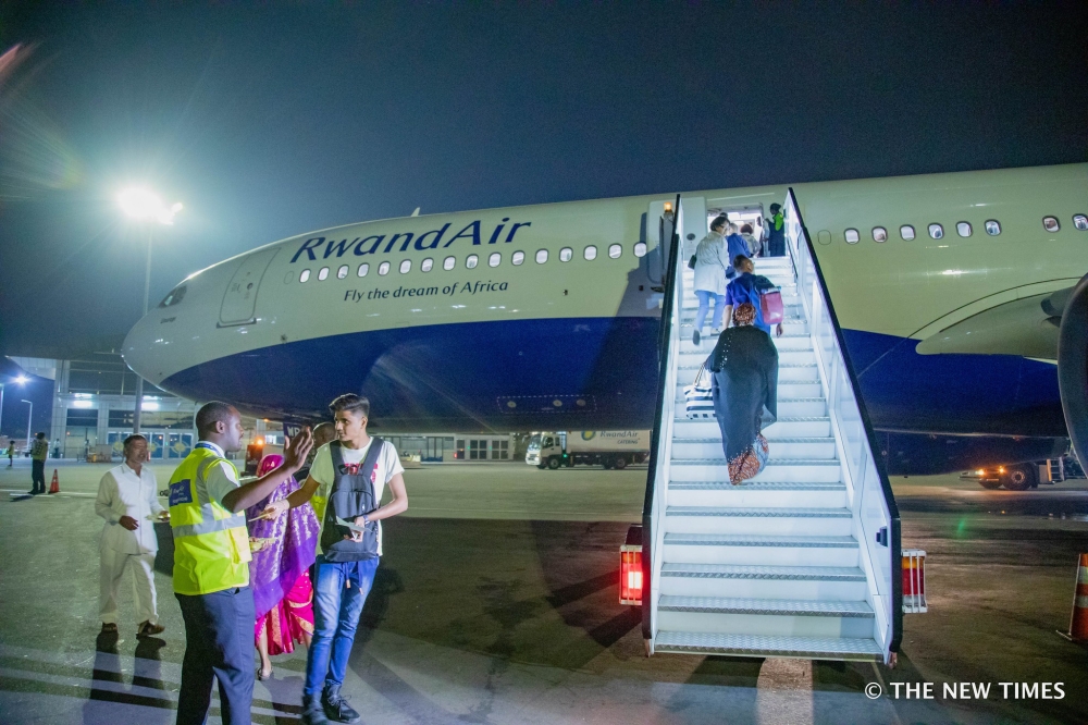 Travellers board a RwandAir&#039;s plane at Kigali International Airport. Under the economic transformation pillar, the government plans to prioritise air transport traffic by supporting RwandAir. File