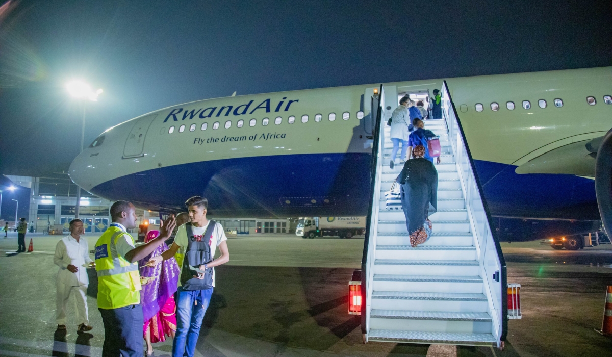 Travellers board a RwandAir&#039;s plane at Kigali International Airport. Under the economic transformation pillar, the government plans to prioritise air transport traffic by supporting RwandAir. File