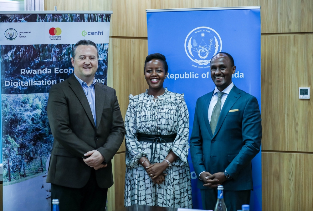 Minister of ICT and Innovation Paula Ingabire, Cenfri’s Managing Director Doubell Chamberlain, and the Country Director for the Mastercard Foundation, David Rurangirwa pose for a photo at the signing ceremony in Kigali on Wednesday, May 8. Photos by Dan Gatsinzi