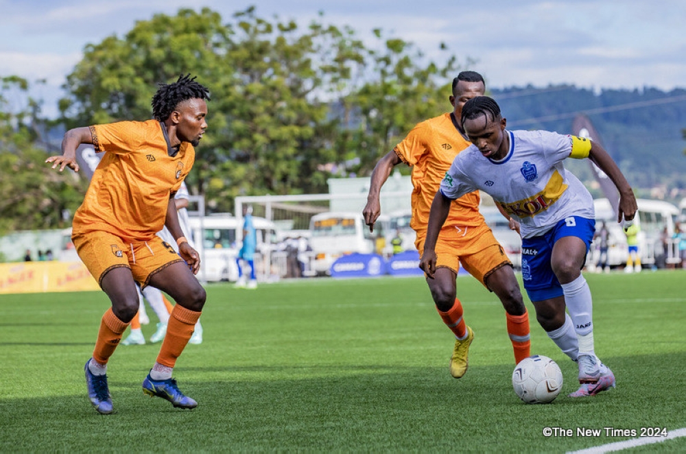 Rayon Sports captain Kevin Muhire tries to go past Bugesera defenders in Peace Cup match.He has confirmed that the Primus NL week 30 game against Kiyovu on Saturday, May 11 will be his last for the club.