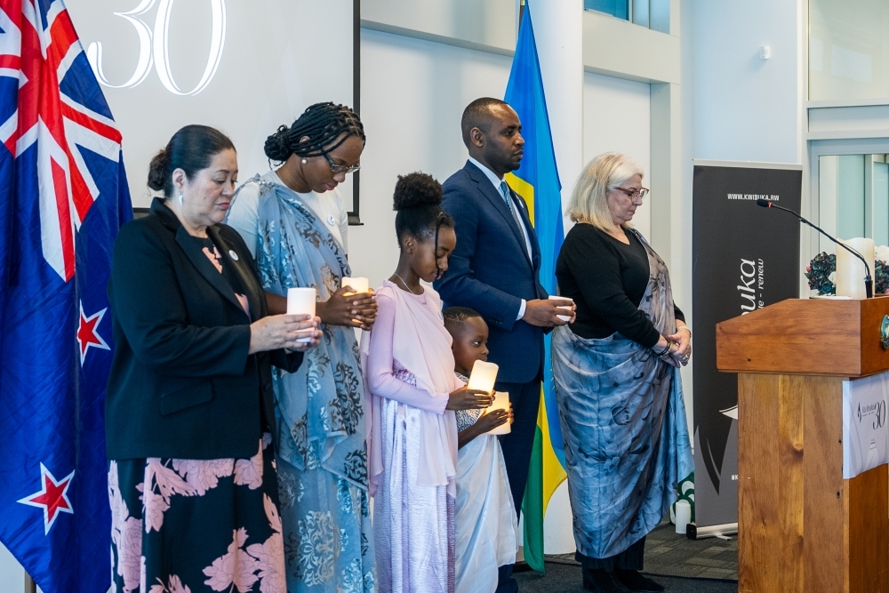 Rwanda’s High Commissioner to New Zealand, Jean de Dieu Uwihanganye (R) with other mourners observe a moment of silence in honour of the victims during the commemoration event in Auckland, New Zealand on April 20,2024. Courtesy