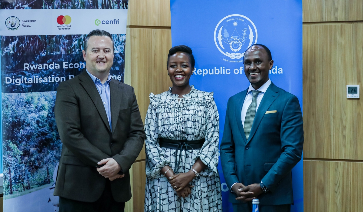 Minister of ICT and Innovation Paula Ingabire, Cenfri’s Managing Director Doubell Chamberlain, and the Country Director for the Mastercard Foundation, David Rurangirwa pose for a photo at the signing ceremony in Kigali on Wednesday, May 8. Photos by Dan Gatsinzi