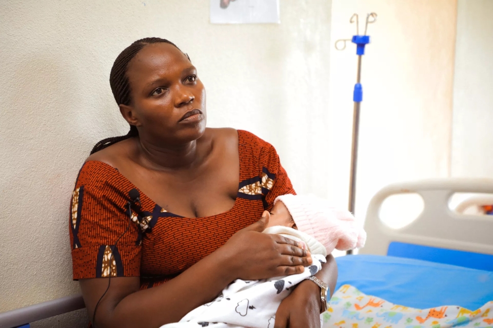 Rehema Kampire, a resident of Rubavu district in Western Rwanda, holds her daughter inside a hospital room. The baby was prematurely born at six months and a half, weighing just 1.3 kilograms. Photo by UNICEF Rwanda