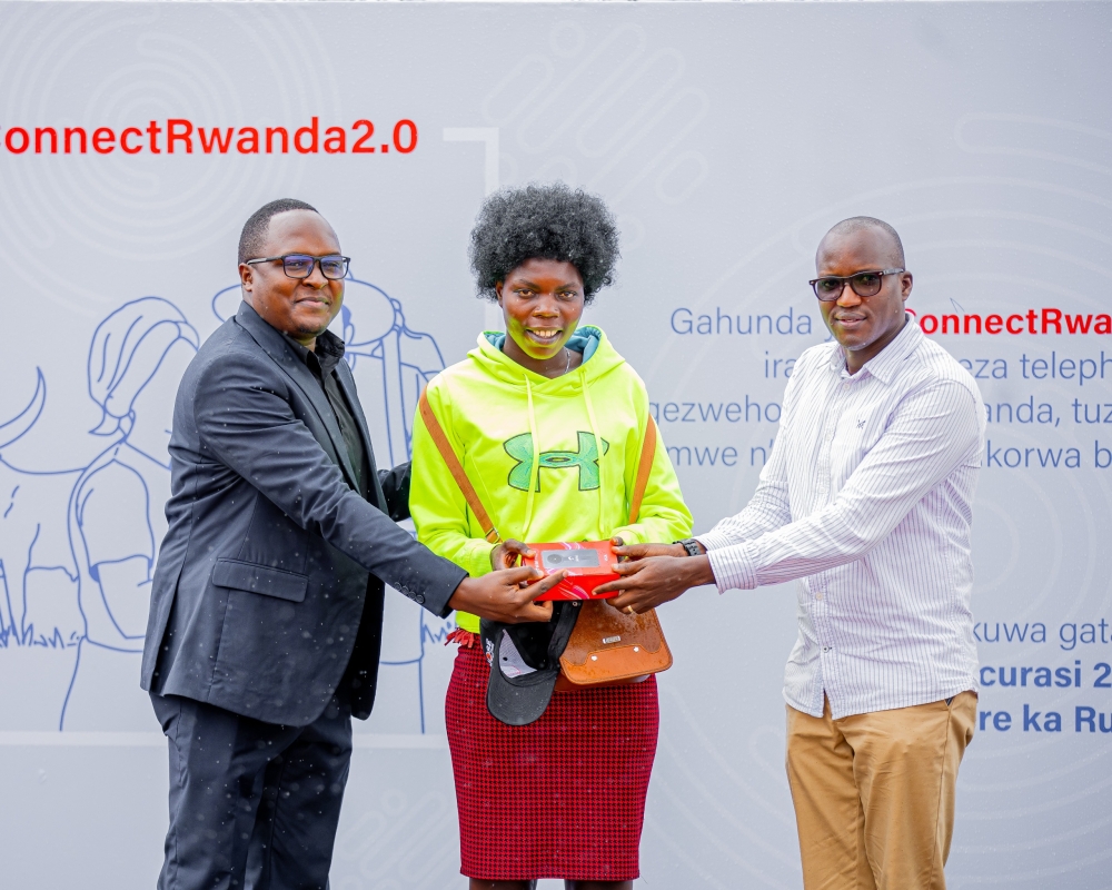 Paulian Kazibwe, the Airtel Rwanda Finance Director(L) hands over a smartphone to one of residents in Rusizi District on Friday, May 10. &#039;ConnectRwanda 2.0&#039;  aims to bring digital connectivity to every corner of Rwanda. Courtesy