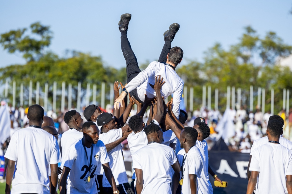 APR FC  head coach Thierry Froger is lifted by his players while celebrating the 22nd national league title on Sunday May 12. Olivier Mugwiza