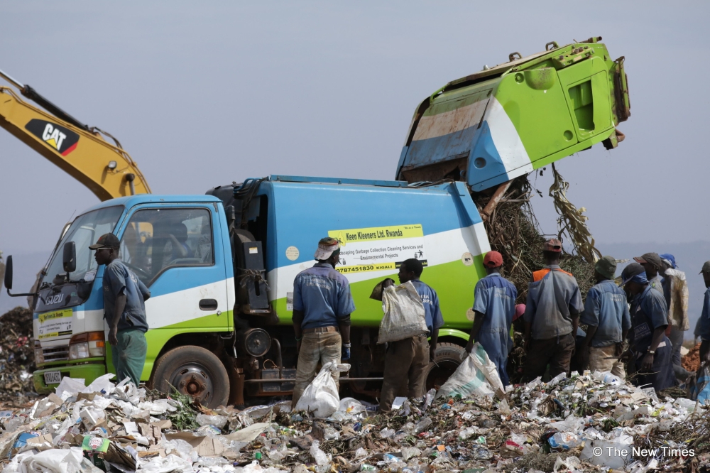 Garbage collectors sorting waste at Nduba landfill in Gasabo District