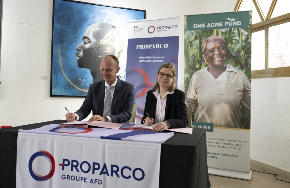 Françoise Lombard, the CEO of Proparco and  One Acre Fund’s CEO, Eric Pohlman sign the agreement in Kigali on Wednesday, May 15. Courtesy