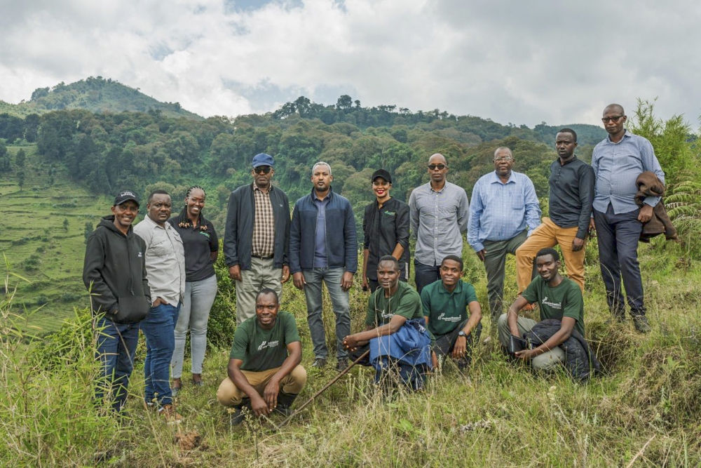 Delegates pose for a group photo as the African Wildlife Foundation (AWF) officially handed over the restored land to the Rwanda Development Board (RDB) for inclusion in the Volcanoes National Park On May 18.