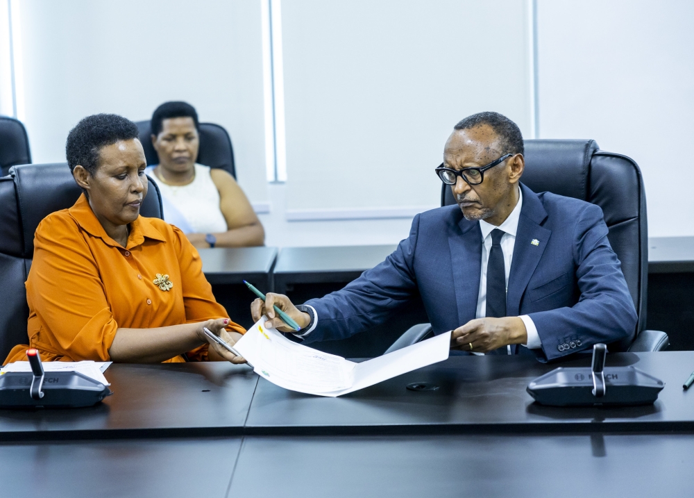 Paul  Kagame  formally submits his candidature for presidency to the Chairperson of the National Electoral Commission, Oda Gasinzigwa on Friday, May 17. Photo by Olivier Mugwiza