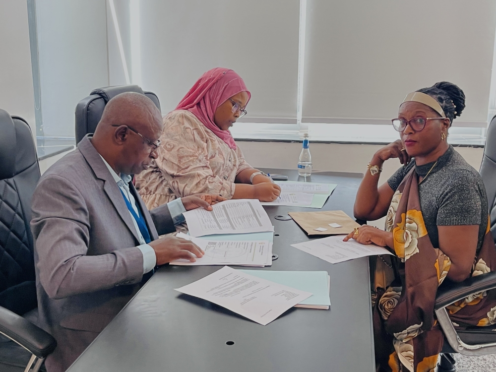 Members of NEC staff (L) check documents of one of aspirants who seek to get a parliamentary position among 24 women MPs (30 per cent quota of 80 MPs making up the Lower House), on May 17, 2024, in Kigali
