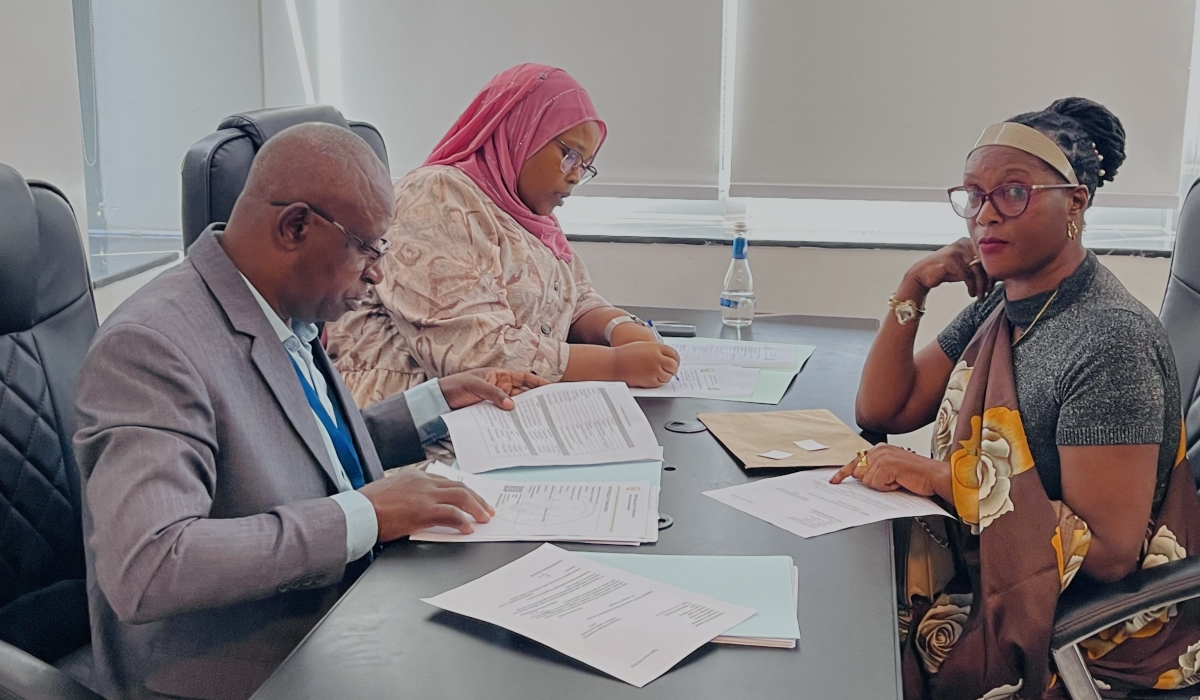 Members of NEC staff (L) check documents of one of aspirants who seek to get a parliamentary position among 24 women MPs (30 per cent quota of 80 MPs making up the Lower House), on May 17, 2024, in Kigali