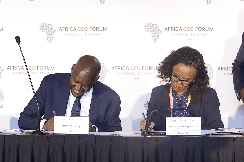 Jeanine Munyeshuli, the Minister of State for Public Investments and Resource Mobilization, and Makhtar Diop, the Managing Director of the International Finance Corporation, signing an agreement in Kigali on May 16. Courtesy