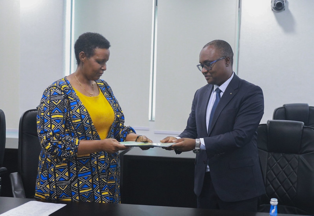 Social Democratic Party (PSD) Secretary-General Jean-Chrysostome Ngabitsinze submits the list of his party’s candidates to NEC Chairperson Oda Gasinzigwa, on Monday, May 20. Craish Bahizi