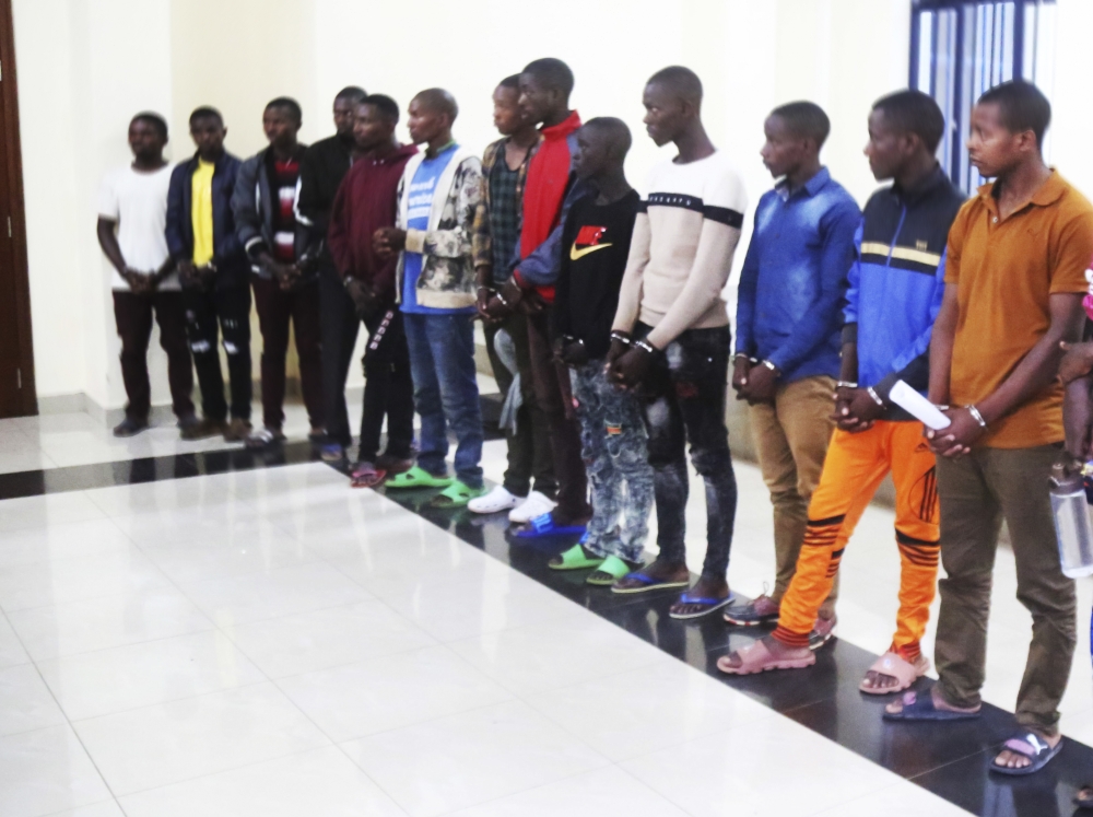 A group of suspects who ran a fraudulent scheme to steal money from people through mobile money. They were paraded at RIB headquarters. File