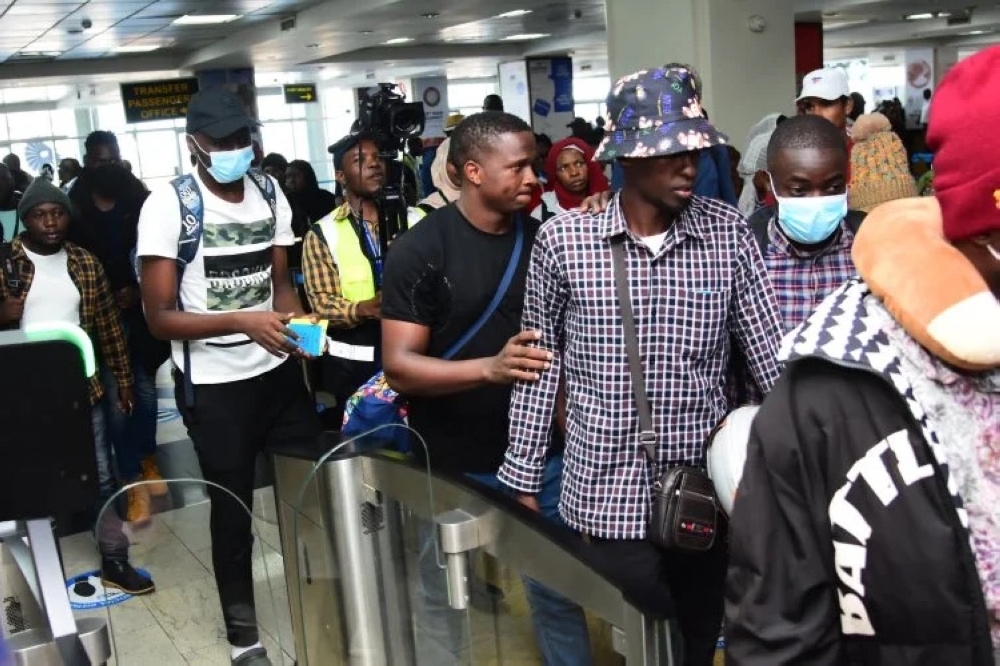 Some of the repatriated 23 Ugandan citizens who were victims of human trafficking in Myanmar, soon after arriving at Entebbe International Airport on Thursday, May 23.