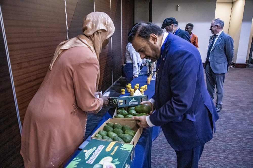 Dr. Nasir Awan, President of the Greater Birmingham Chamber of Commerce, checks out avocados from a local producer on the exhibition stand during the Rwanda-UK Trade Mission in Kigali on Tuesday, May 28. Photos by Emmanuel Dushimimana for The New Times