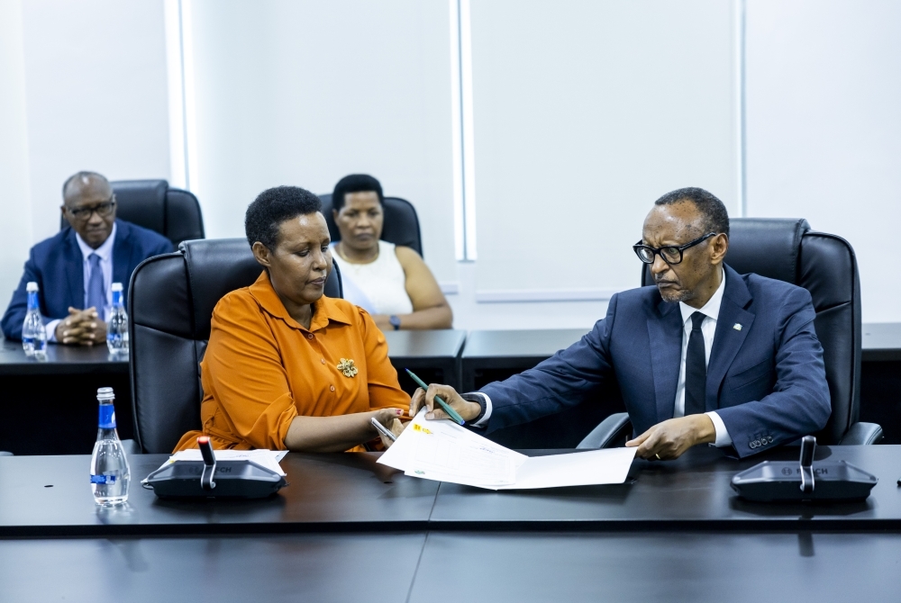 President Paul Kagame (R) presents his candidature to the Chairperson of the National Electoral Commission, Oda Gasinzigwa, on May 17, 2024, as he seeks re-election as the Head of State (courtesy)