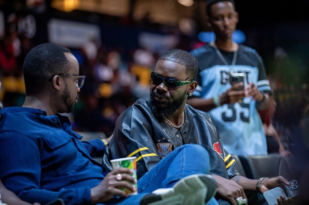 Coach Gael (L), founder of 1 55AM music label, interacts with Nigerian musician Adekunle Gold(R)-Dan Gatsinzi