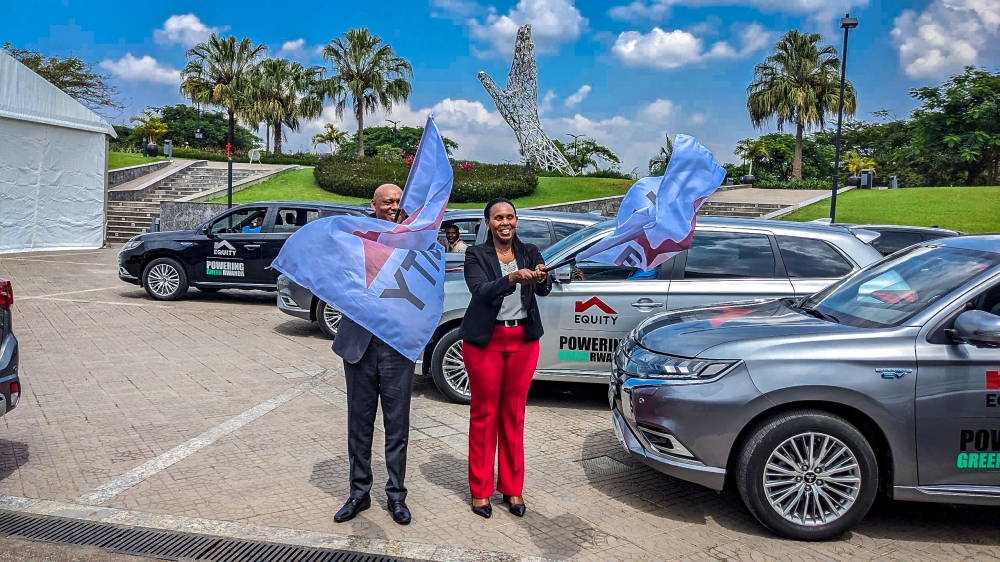 Equity Bank Rwanda Plc Managing Director, Hannington Namara and Claudine Uwera, the Minister of State for the Environment in the Ministry of Environment flag off hybrid and electric cars recently acquired by the bank as part of their commitment to sustainable living, in Kigali on Tuesday, June 4. All photos by Craish Bahizi