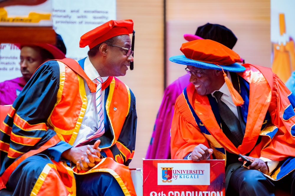 Chairman of the Board of Promoters, Prof. Nshuti Manasseh, interacts with Philibert Afrika, Chairman of the University Governing Body at the graduation ceremony on May 31. Courtesy