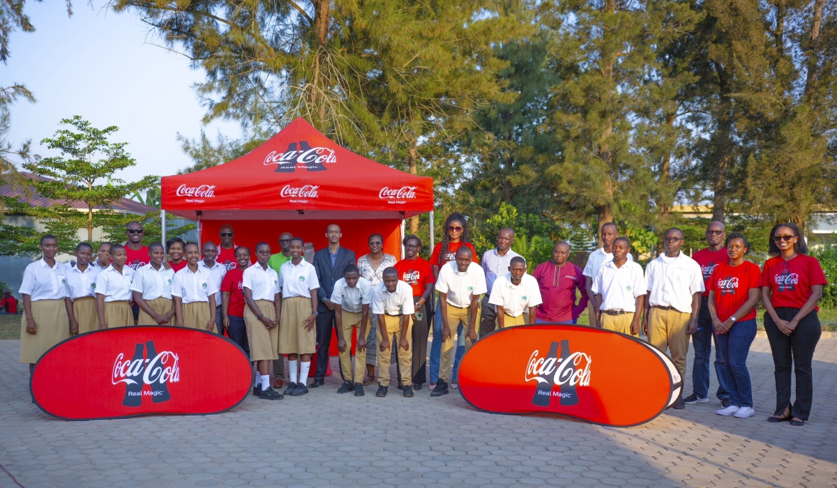 School officials and Bralirwa staff pose for a photo as they donated garbage collection tools to schools in Kicukiro