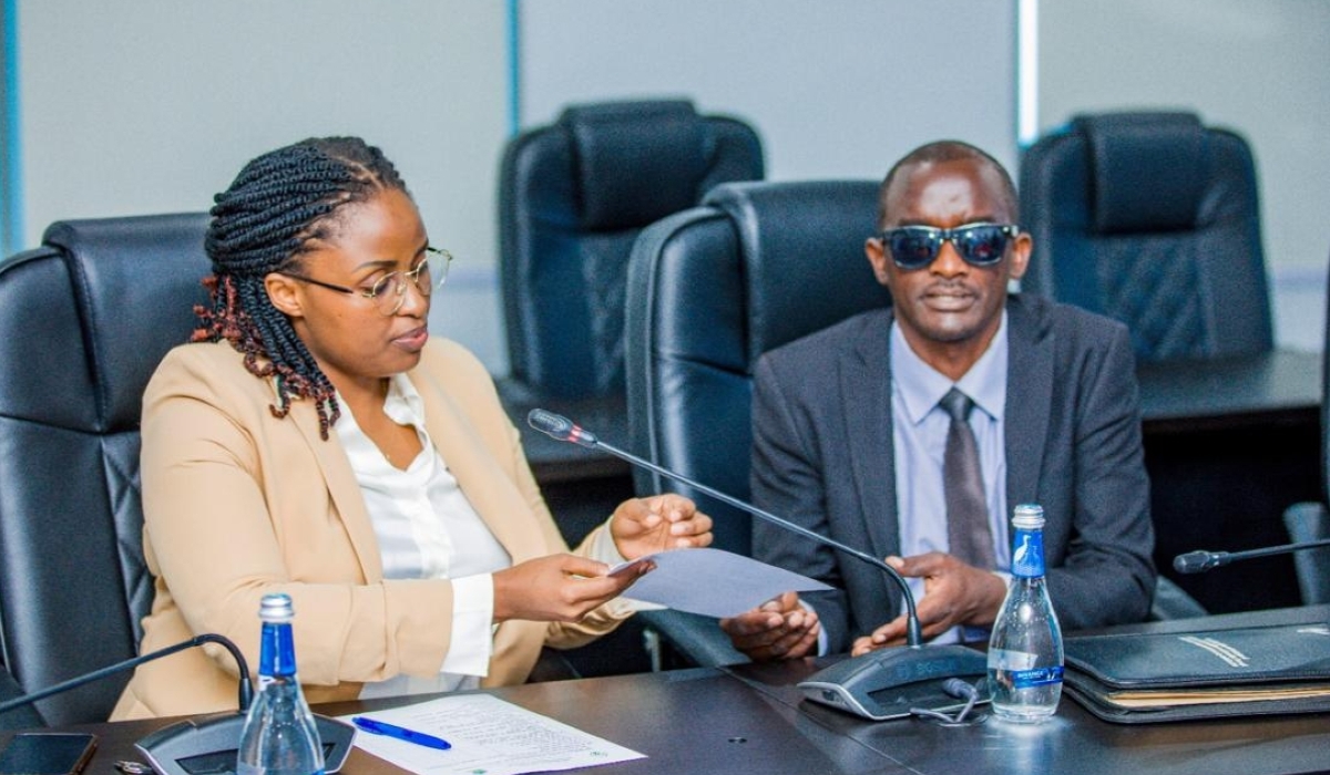 Fredrick Habamuremyi submits his candidacy  to a NEC official, on Tuesday, May 28. Courtesy