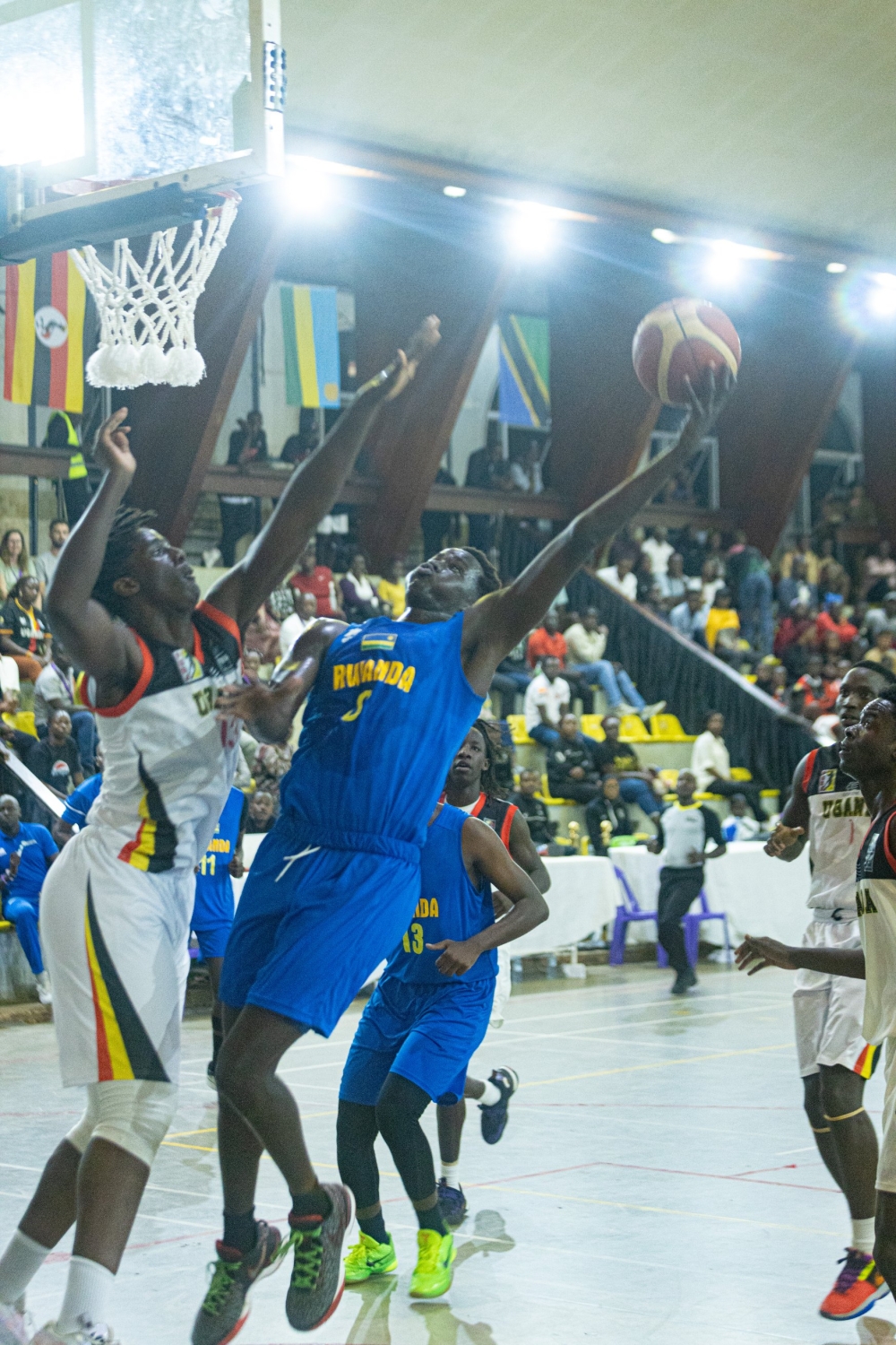 A Ugandan players tries to block his Rwandan opponent from shooting the ball as the hosts beat Rwanda 78-49 to maintain their unbeaten run at the Afrobasket U18 qualifiers-courtesy