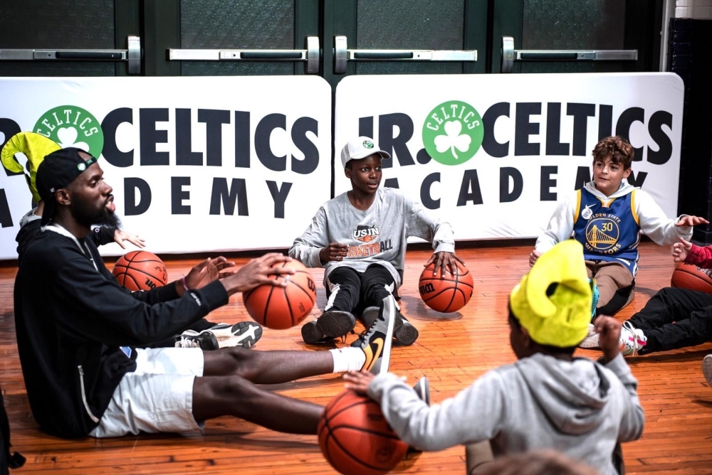 Rwandan international basketball coach Ali Rugira gives instructions to young children during a coaching course. Courtesy