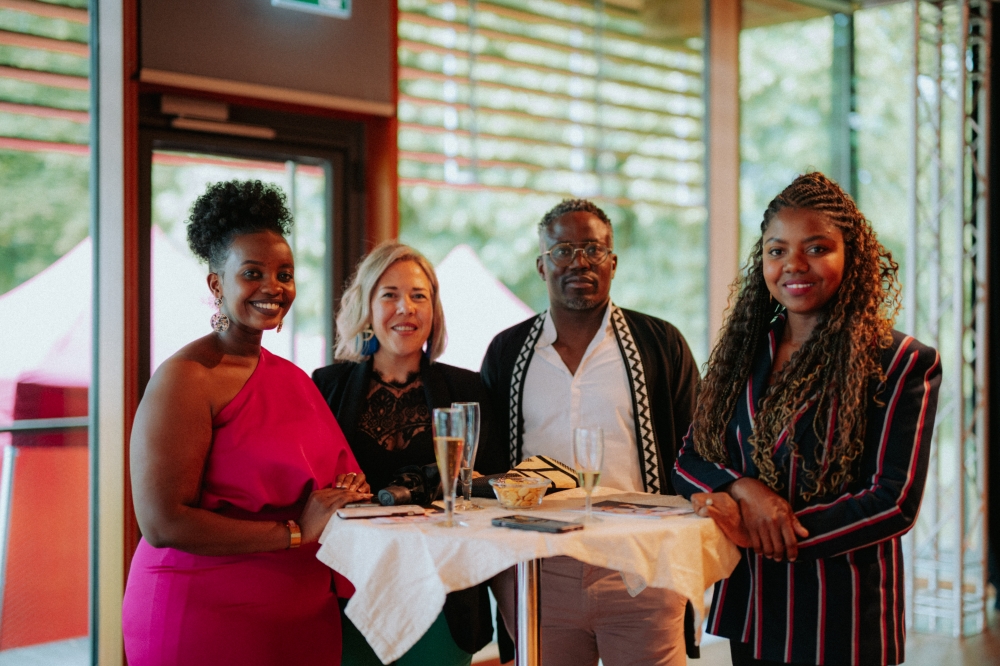 &#039;Tying Knots&#039; curator Jemima Kakizi (L) shares a light moment with members of Rwandan diaspora who showed up to support her exhibition on June 21-Photo by Oli Frisch
