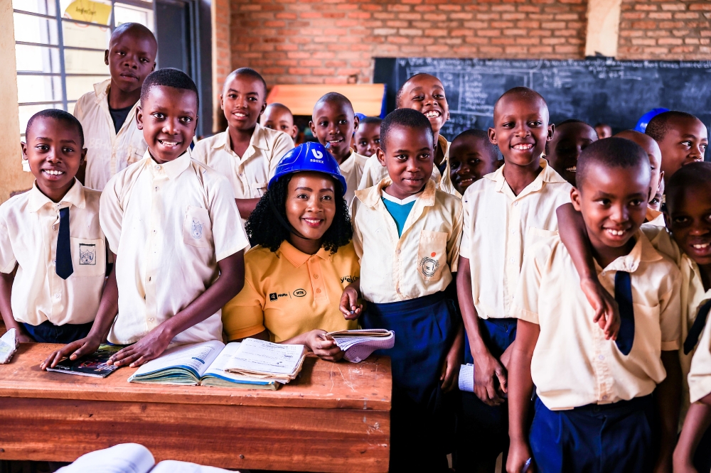 MTN Rwanda’s Chief Executive Officer Mapula Bodibe with students as MTN staff installed solar panels at GS Agateko. Craish Bahizi.