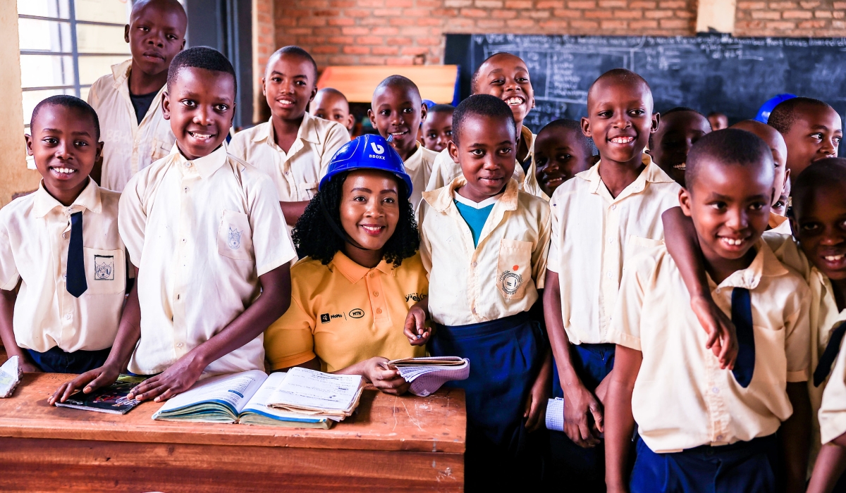 MTN Rwanda’s Chief Executive Officer Mapula Bodibe with students as MTN staff installed solar panels at GS Agateko. Craish Bahizi.