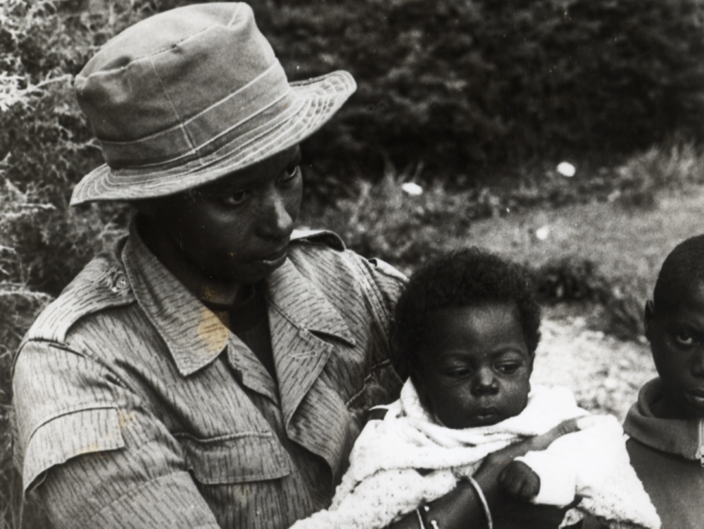 An RPA (now RDF) soldier holding a rescued baby right after the Genocide Against the Tutsi | Rwanda 1994