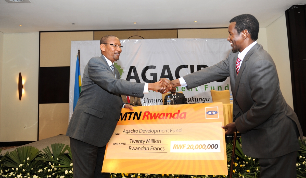 Minister John Rwangombwa recieves MTN Rwanda&#039;s contribution during the launch of Agaciro Development Fund on August 23, 2012. File