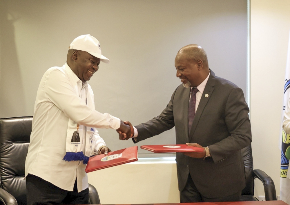 The Central African Republic’s Mouvement Cœurs Unis National Executive Secretary Simplice Sarandji and RPF-Inkotanyi Secretary General Wellars Gasamagera exchange documents after signing a party-to-party bilateral agreement, in Kigali, on Wednesday, July 17. Courtesy